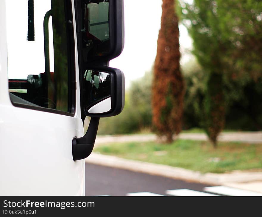 Horinzontal view of door and mirrors of white  truck. Horinzontal view of door and mirrors of white  truck