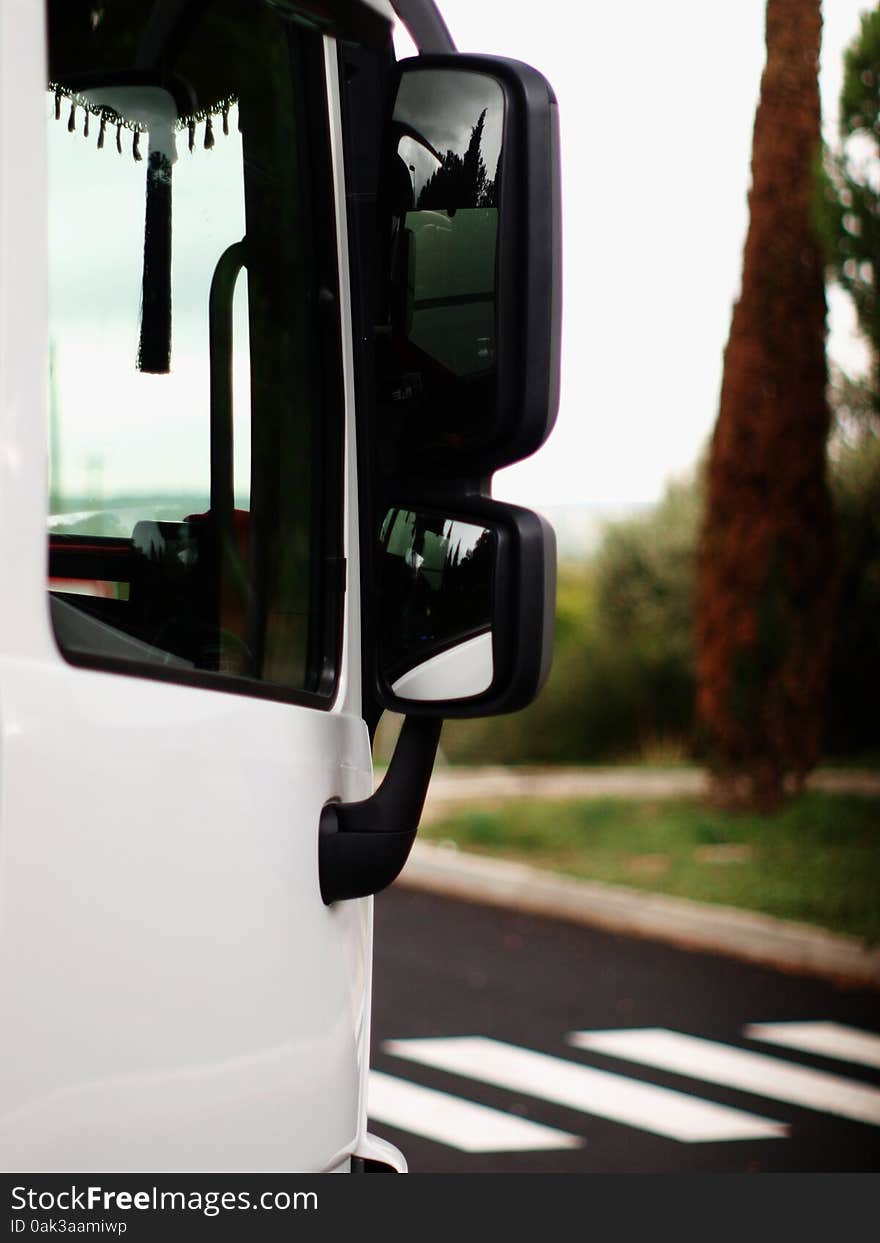 Door and window view of a white truck on vertical.Blur background. Door and window view of a white truck on vertical.Blur background.