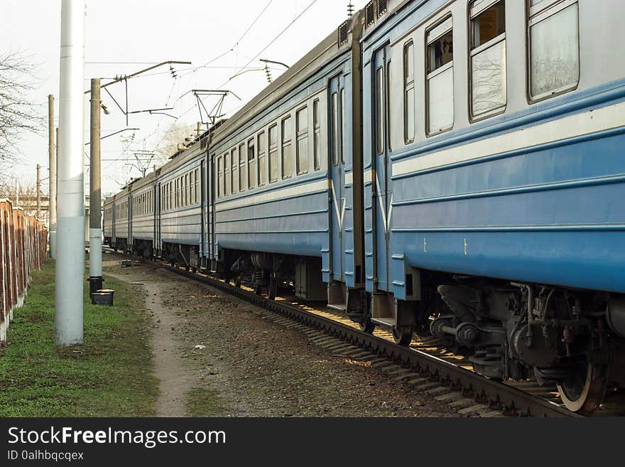 Blue suburban train moves diagonally in the picture. Blue suburban train moves diagonally in the picture