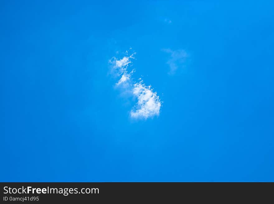 Small White Clouds On Light Blue Clear Sky