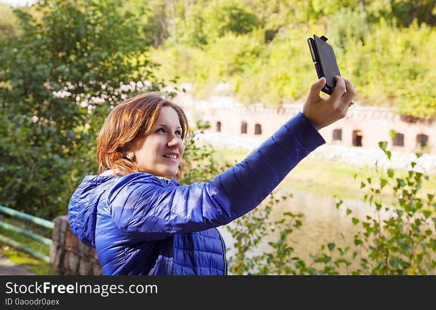 Young girl photographing herself a mobile phone