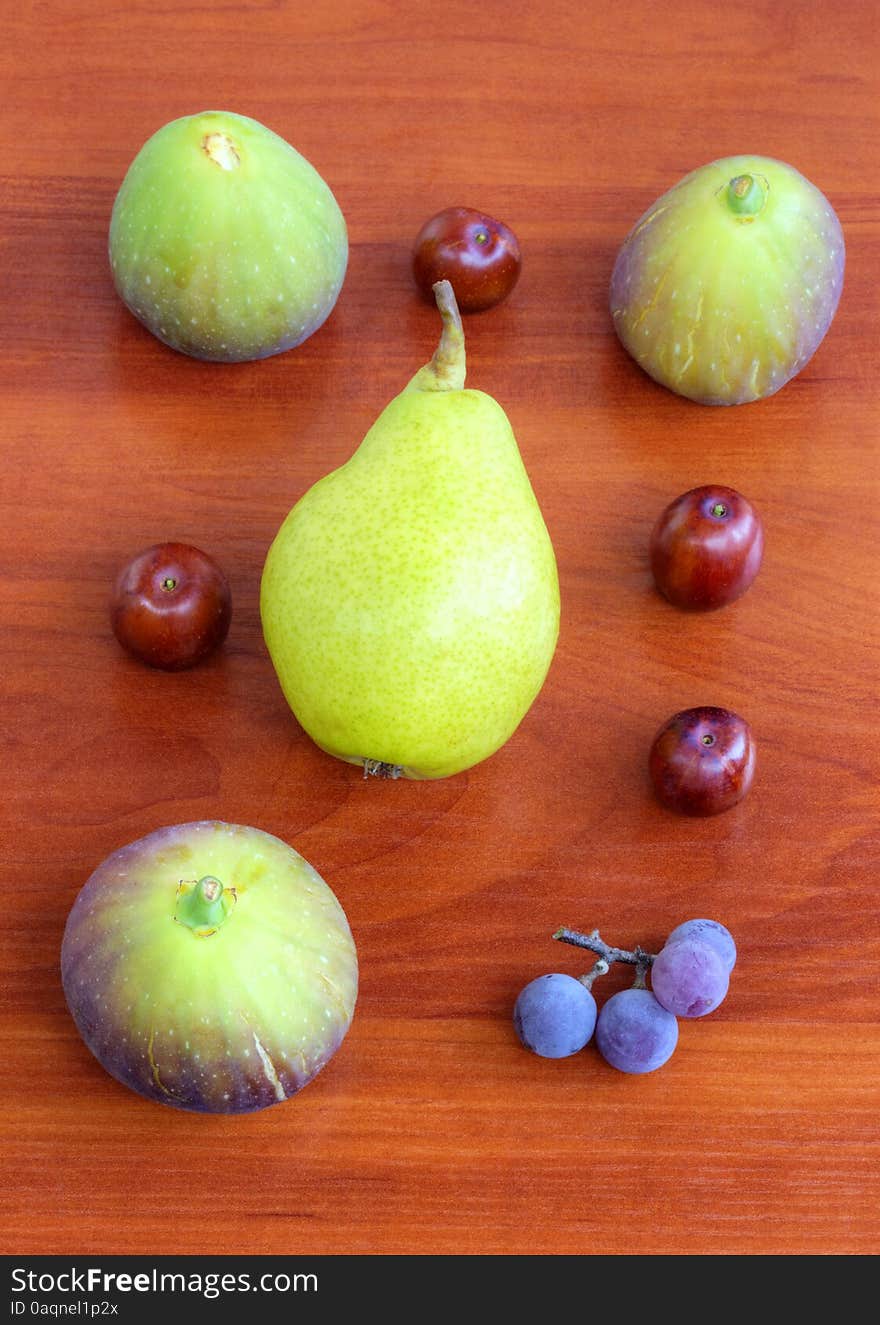 Fresh fruits on wooden background closeup