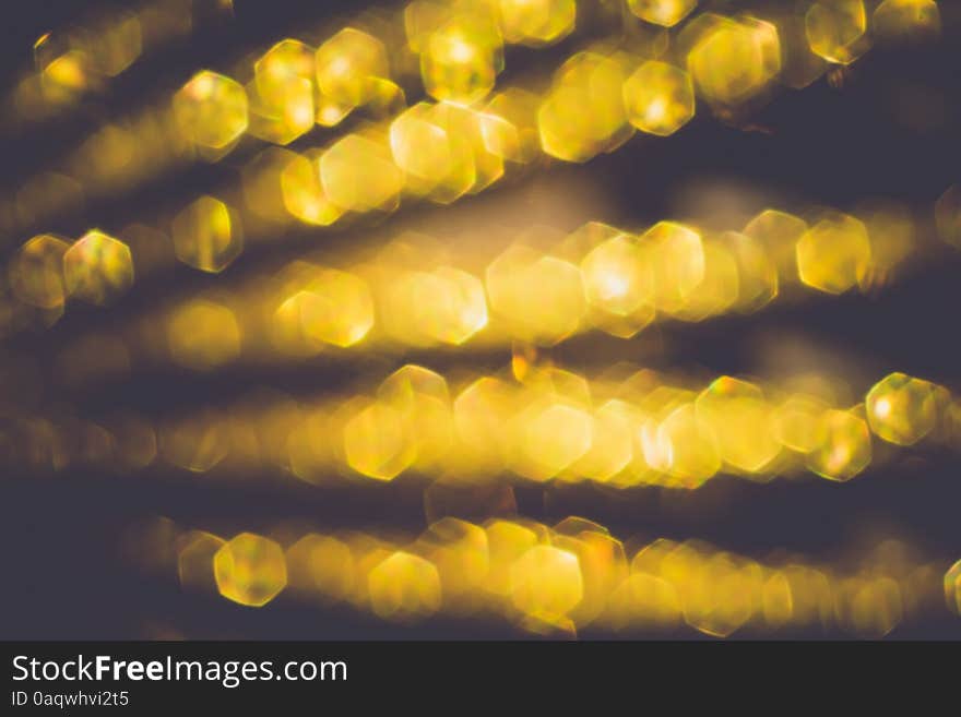 Festive background with defocused golden glitters, bokeh effect. Festive background with defocused golden glitters, bokeh effect.