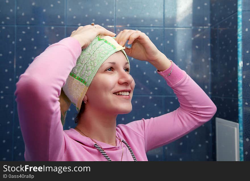 Woman in a bathroom with a towel on her head