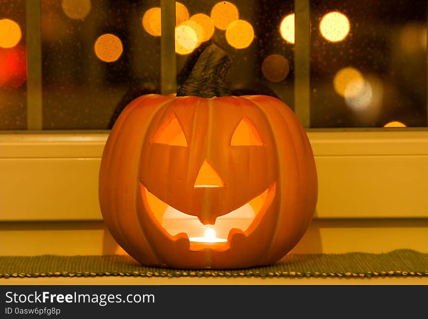 Halloween pumpkins lying on the window sill