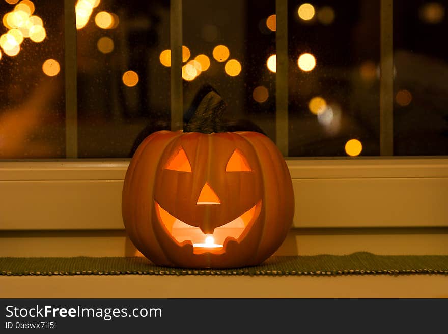 Halloween pumpkins lying on the window sill