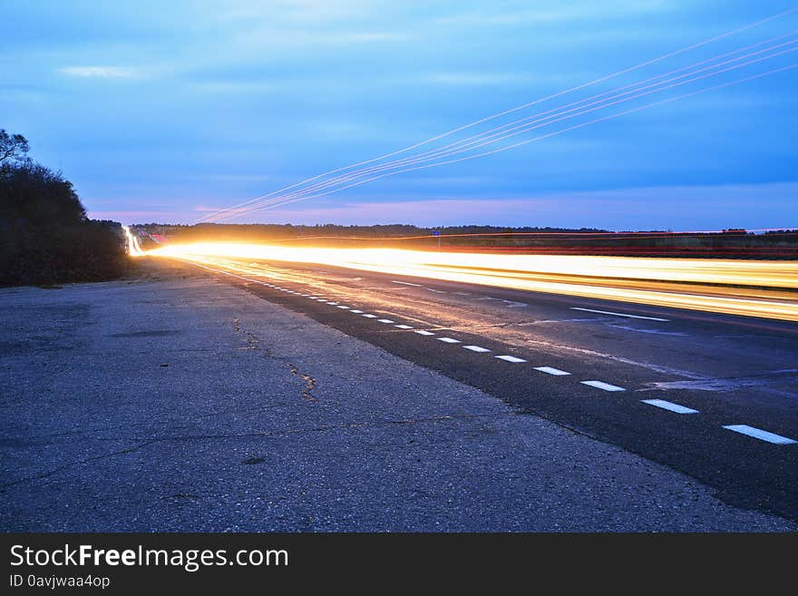 Streaks of light from car headlights on the road