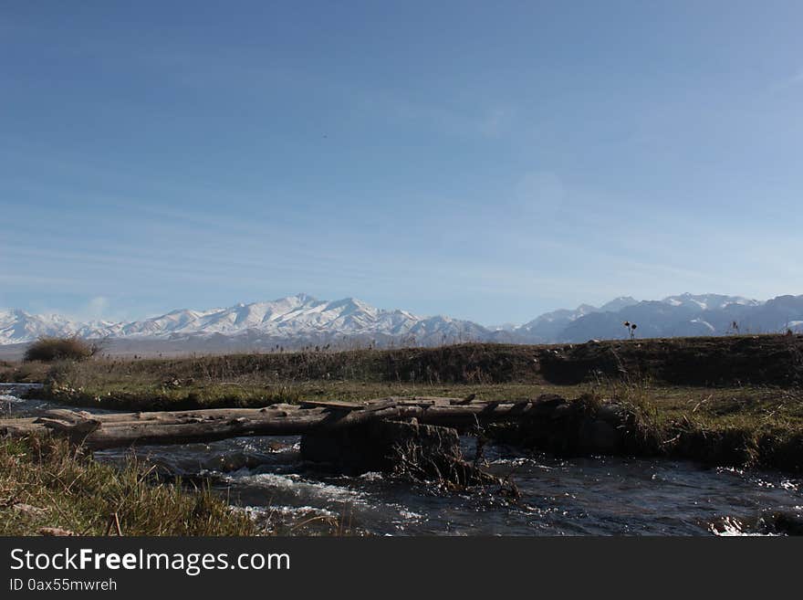 A bridge over a small river in the Talas region of Kyrgyzstan. Mountains in the background. A mountainous and remote region of Kyrgyzstan. A bridge over a small river in the Talas region of Kyrgyzstan. Mountains in the background. A mountainous and remote region of Kyrgyzstan.