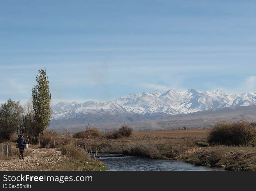 A bridge over a small river in the Talas region of Kyrgyzstan. Mountains in the background. A mountainous and remote region of Kyrgyzstan. A bridge over a small river in the Talas region of Kyrgyzstan. Mountains in the background. A mountainous and remote region of Kyrgyzstan.