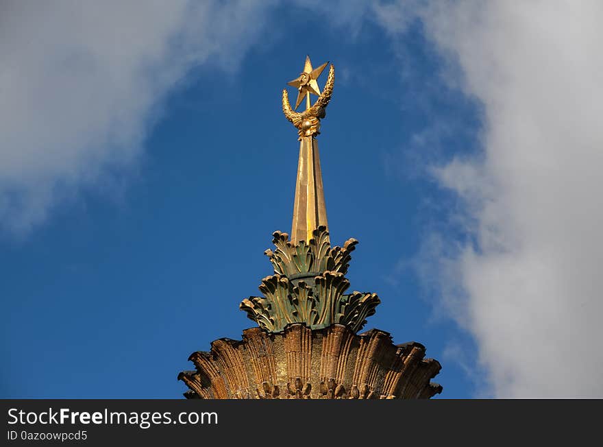 The spire with the emblem of the Soviet Union on the Ukraine pavilion at All-Russia Exhibition Centre (VDNH)