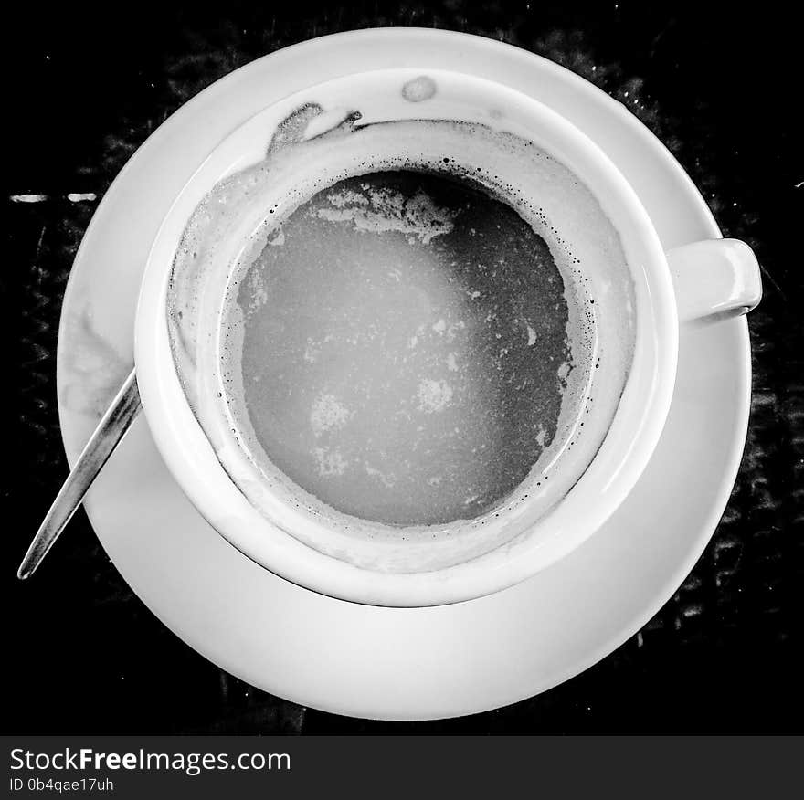 White classic teacup with herbal refreshment tea on the table. White classic teacup with herbal refreshment tea on the table