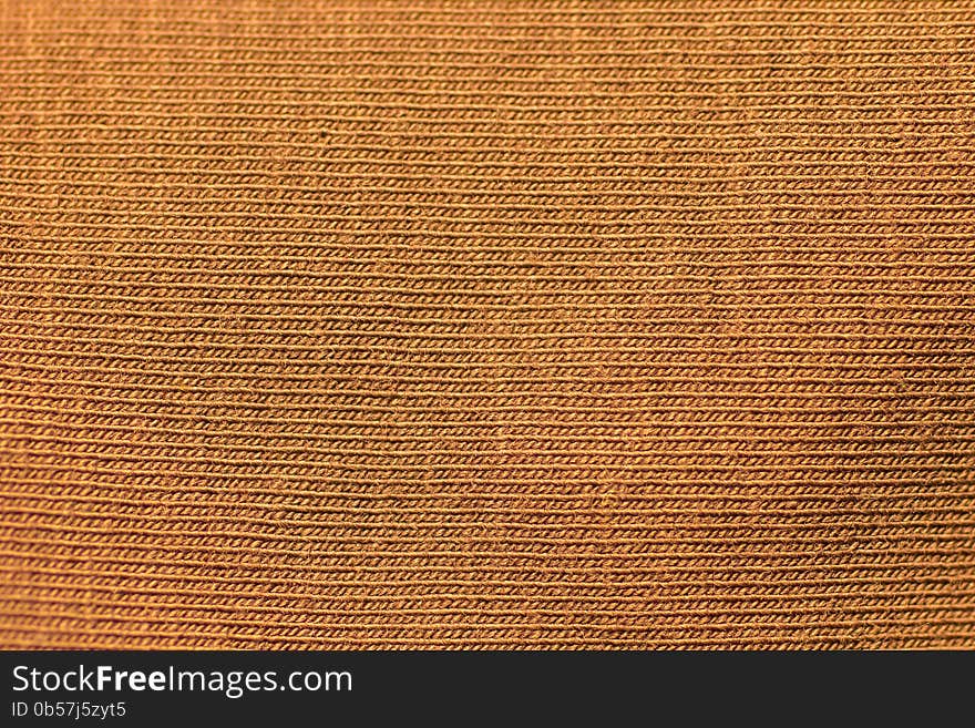 Gold unusual texture of an orange knitted fabric. Gold unusual texture of an orange knitted fabric