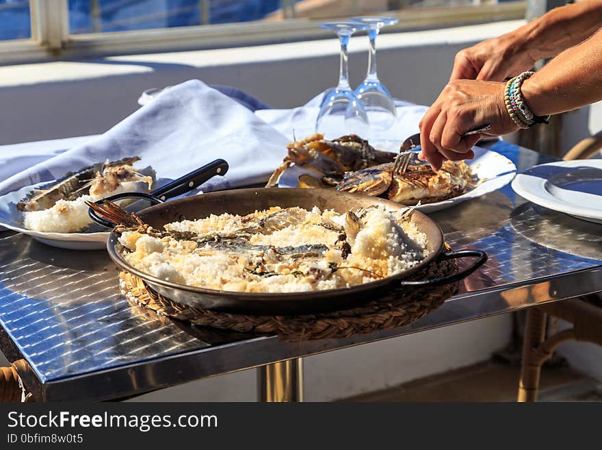 Waiter filleting salted fish at table side. Waiter filleting salted fish at table side