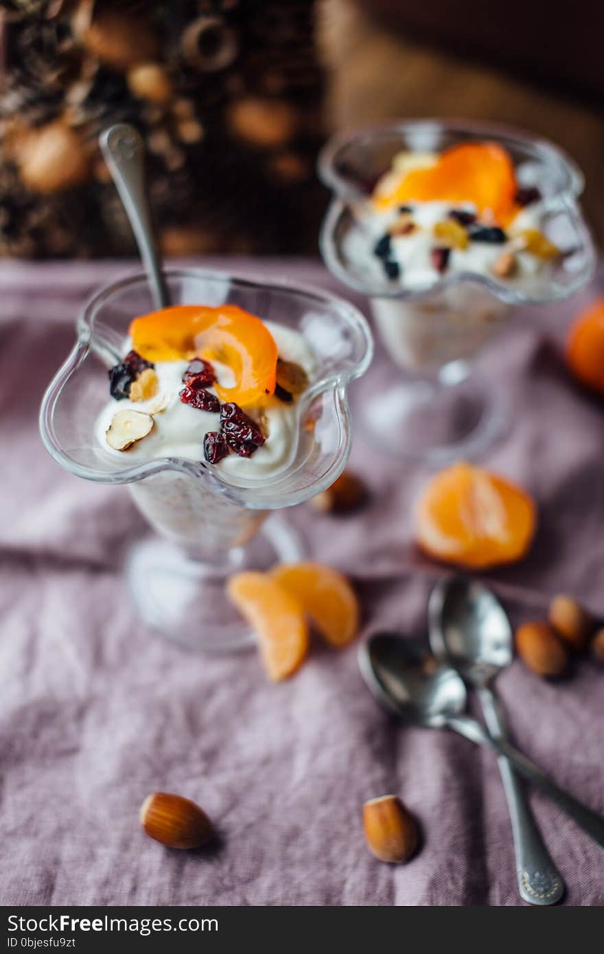 Healthy breakfast with oranges, nuts and ice cream