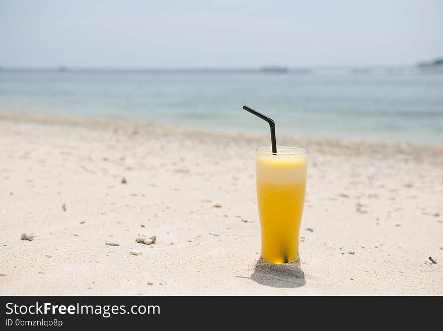 Stock picture of fresh pineapple juice on the beach