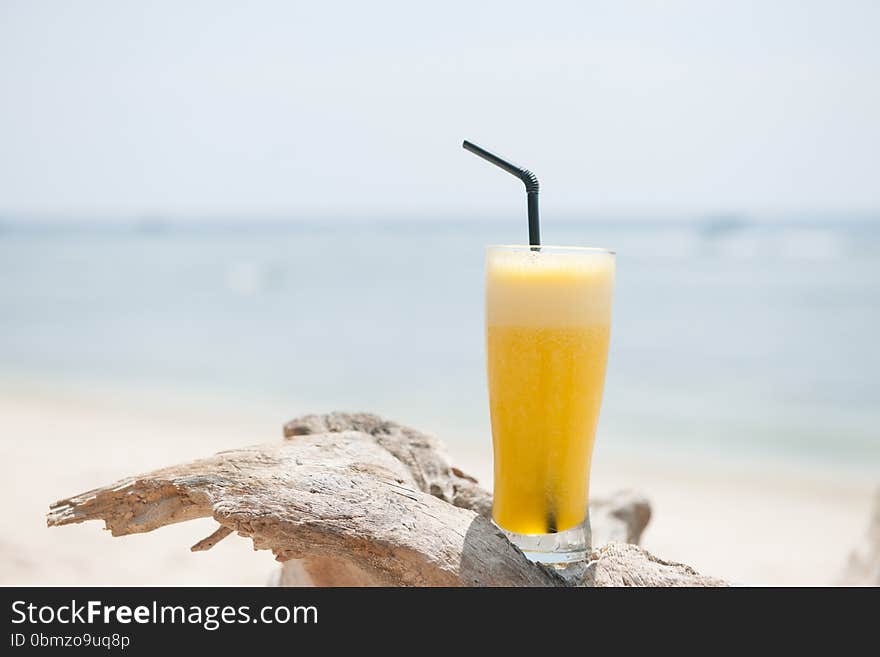 Stock picture of fresh pineapple juice on the beach