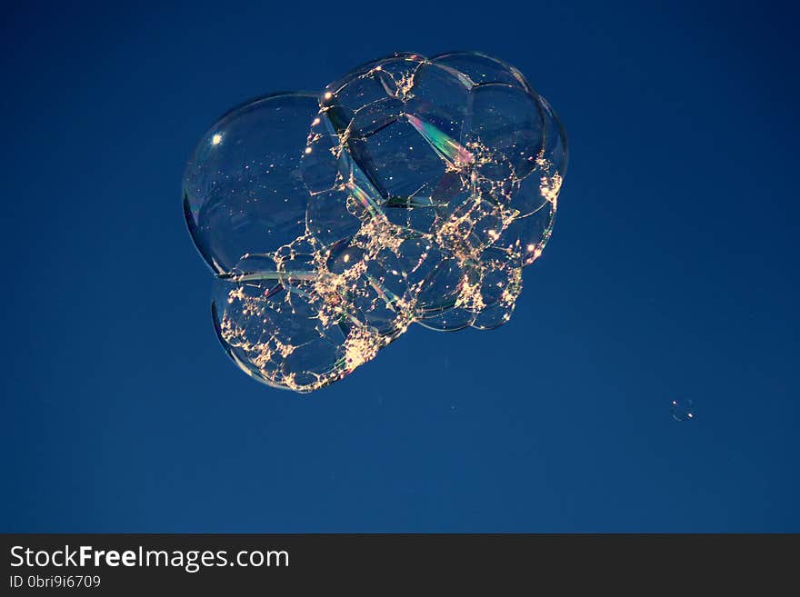 Shimmering floating bubble cluster with bokeh effect. Shimmering floating bubble cluster with bokeh effect