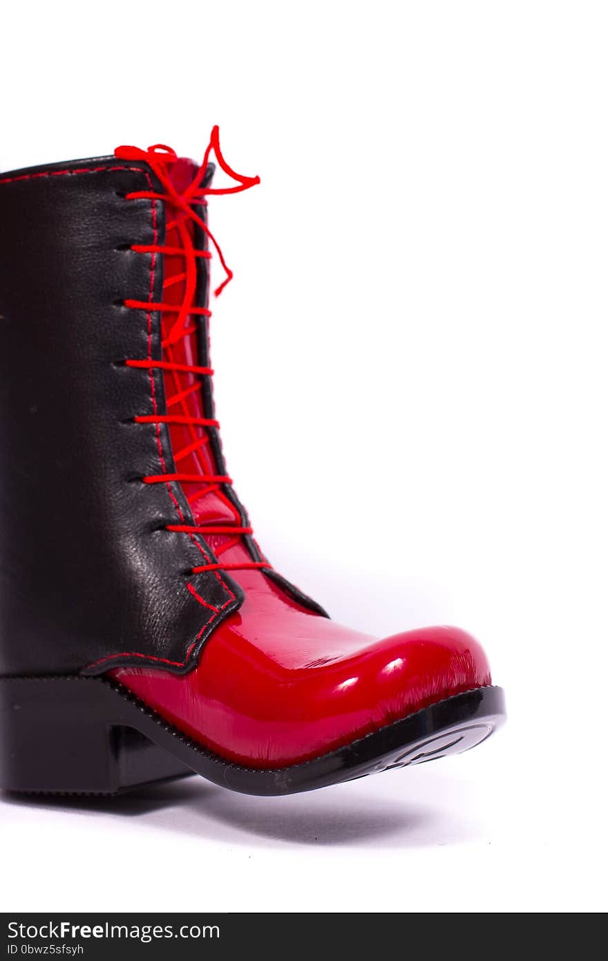 Black and red glossy women's boots on a white background. Black and red glossy women's boots on a white background