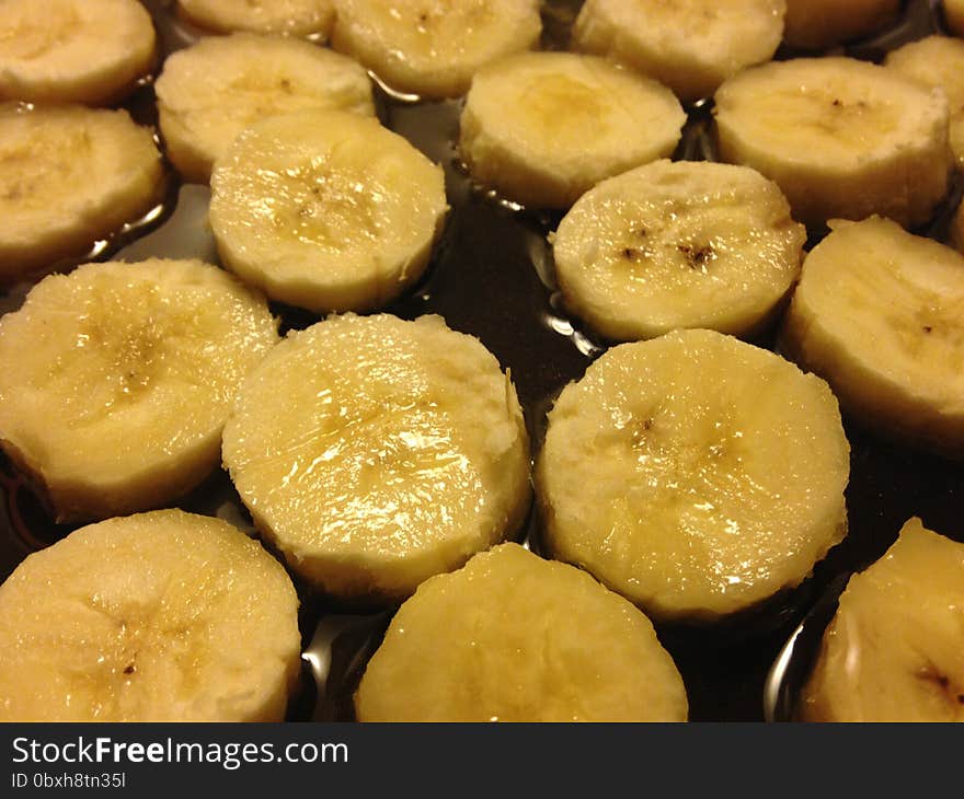 Sliced Bananas on Frying Pan in Oil.