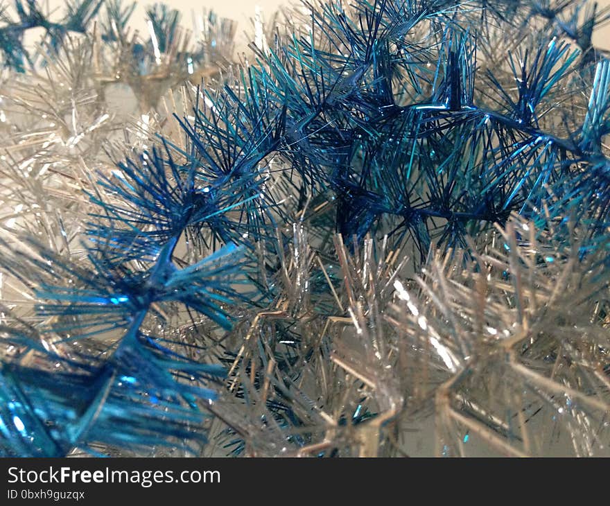 Silver and Blue Christmas Tinsel on White Background. Silver and Blue Christmas Tinsel on White Background.