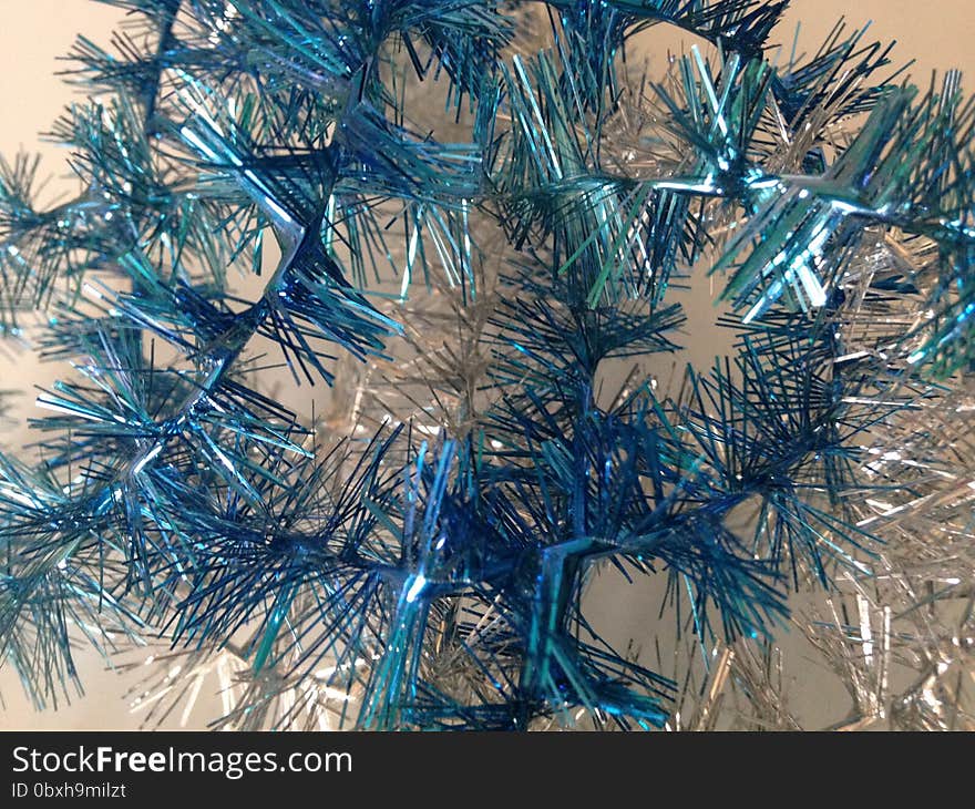 Silver and Blue Christmas Tinsel on White Background. Silver and Blue Christmas Tinsel on White Background.