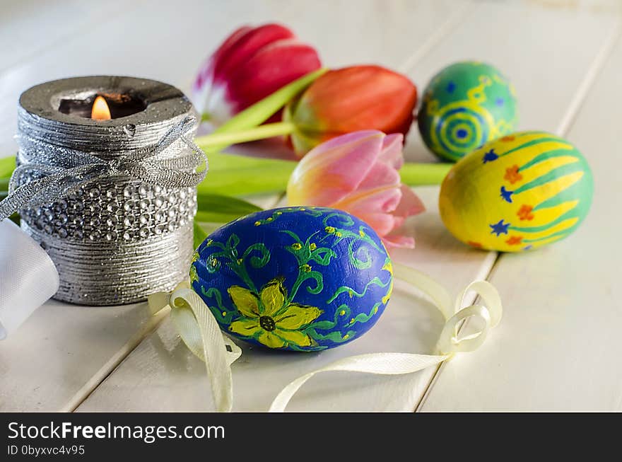 Easter eggs and colorful spring flowers on a white background. Easter eggs and colorful spring flowers on a white background