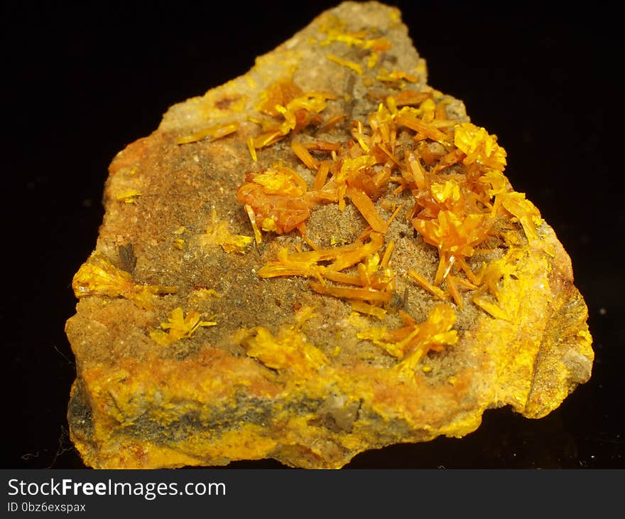 Orpiment a.ka. auripigment commonly occurs in hydrothermal veins of low temperatures. One of the basic ores of arsenium