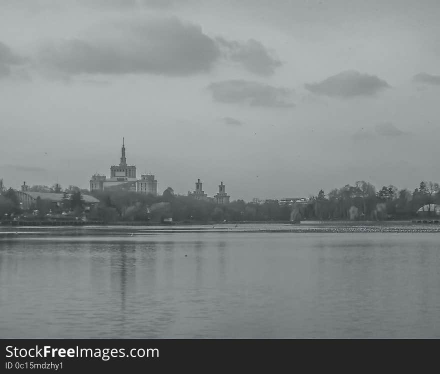 Overfiltered urban landscape edit with bucharest house press view from the herastrau lake in the winter morning fog