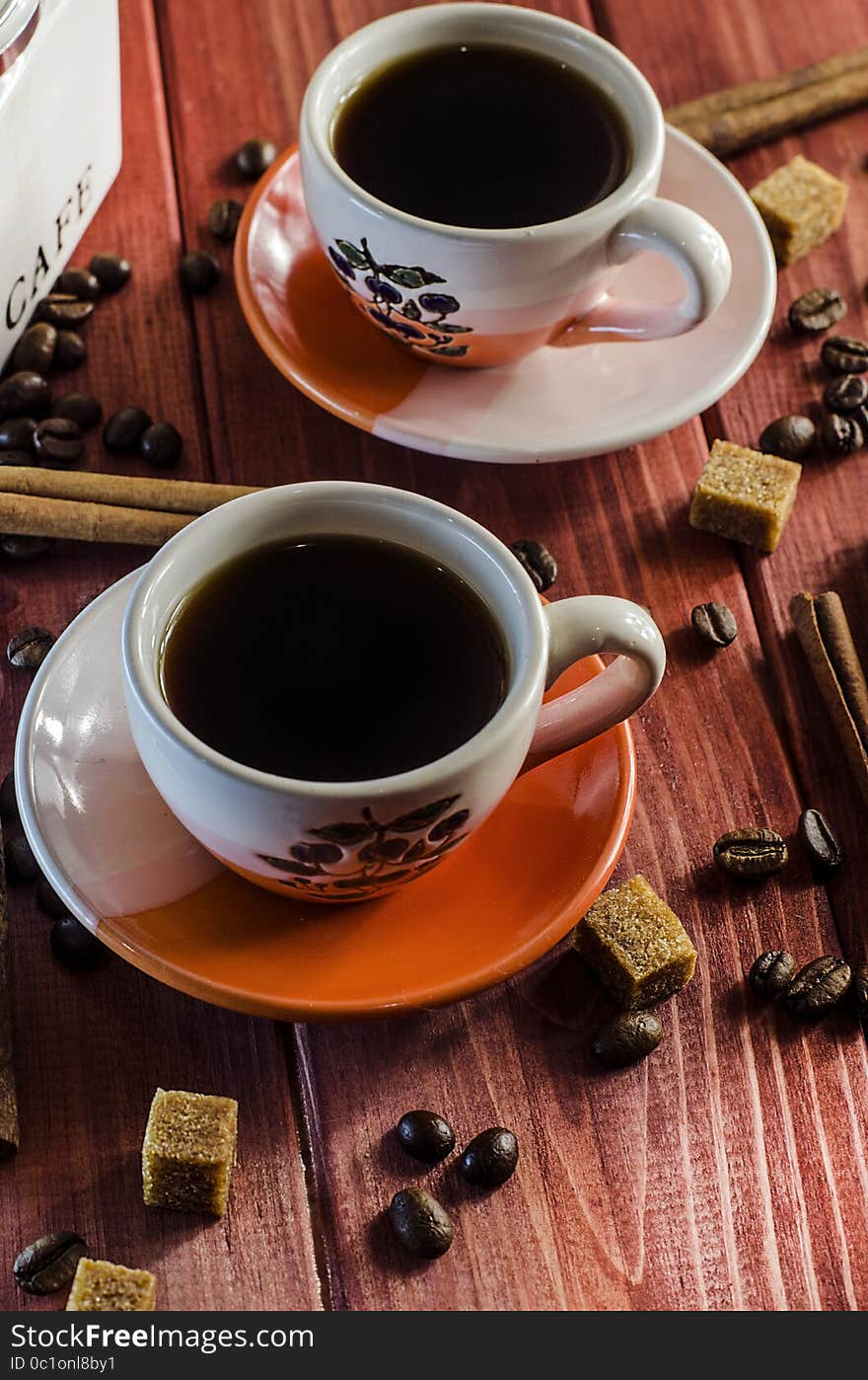 Brewed coffee and coffee beans with cinnamon