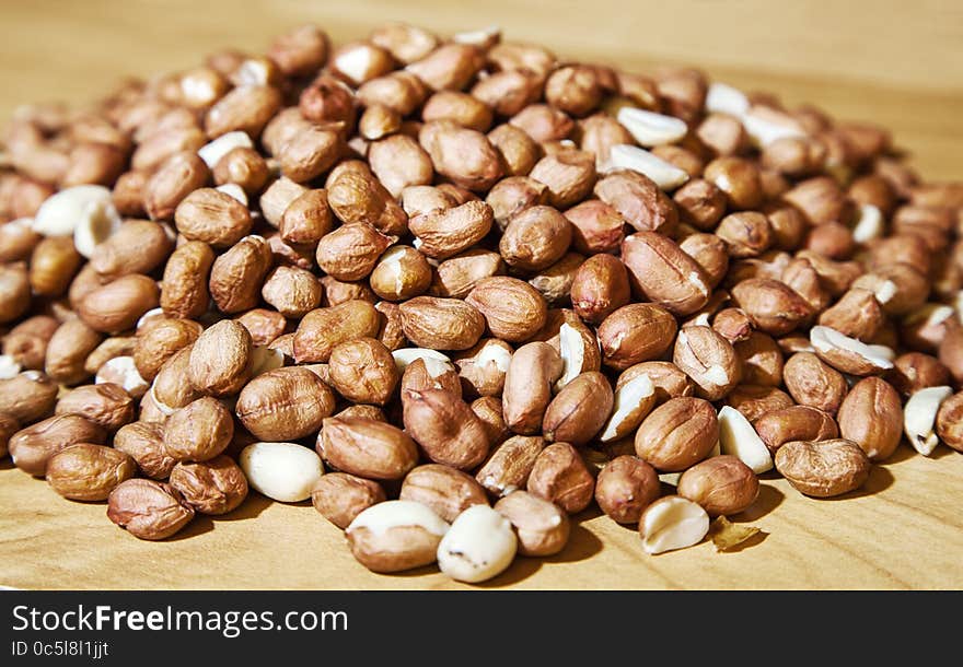 Large pile of peanuts on the table closeup