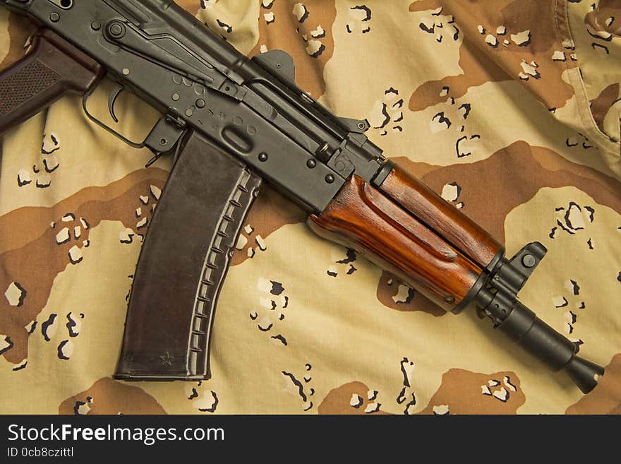 A Russian AKS-74U assault rifle, lying on US designed six-colour desert pattern camouflage, commonly known as chocolate chip. Originally created for rear echelon troops the AKS-74U quickly became highly prized by Russian special forces, and more recently by urban terrorists, because of its compact size. A Russian AKS-74U assault rifle, lying on US designed six-colour desert pattern camouflage, commonly known as chocolate chip. Originally created for rear echelon troops the AKS-74U quickly became highly prized by Russian special forces, and more recently by urban terrorists, because of its compact size.