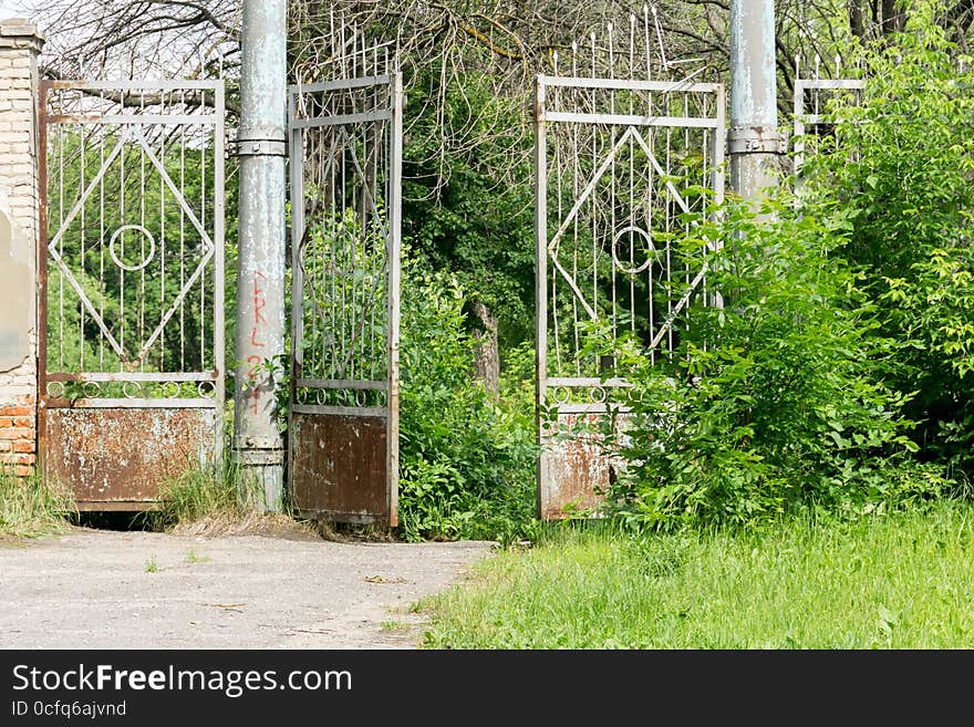 Abandoned rural stadium metal gate and green foliage. Abandoned rural stadium metal gate and green foliage.