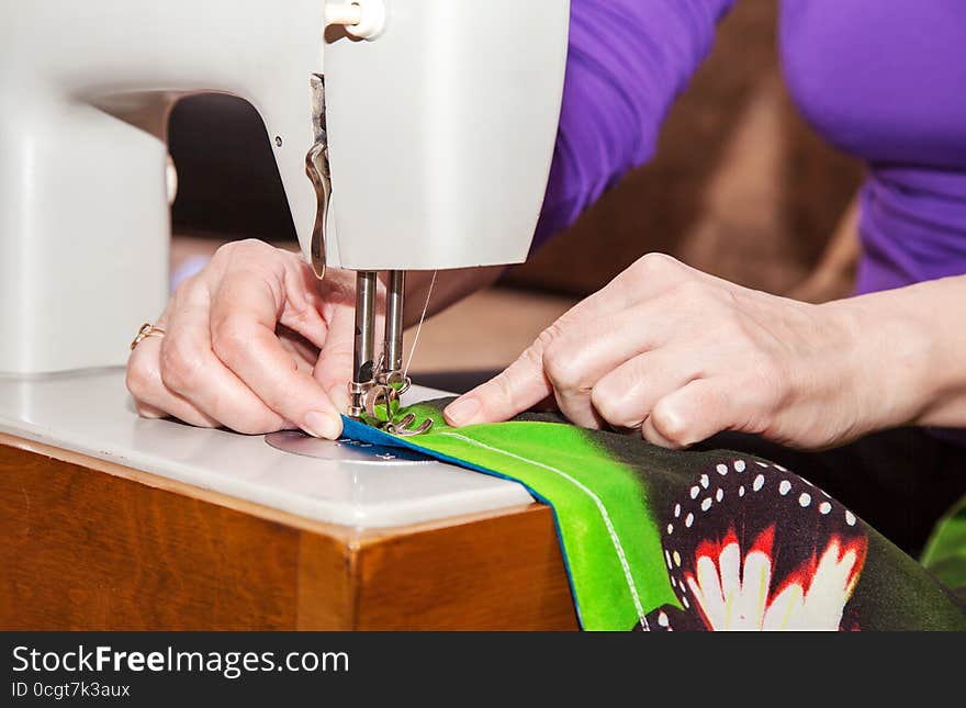 Woman s hands sewing on the sewing machine