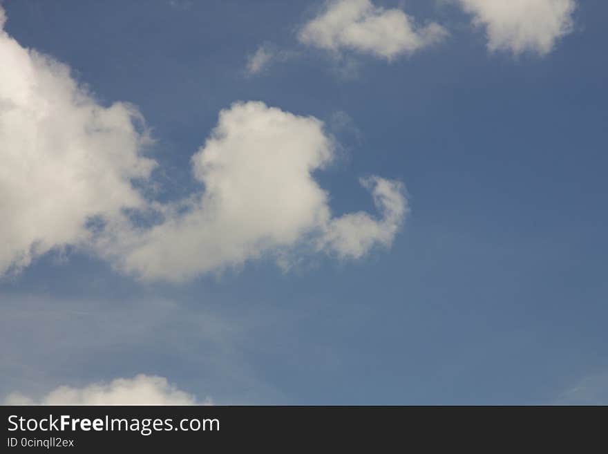 Fluffy white clouds in the blue sky. Fluffy white clouds in the blue sky