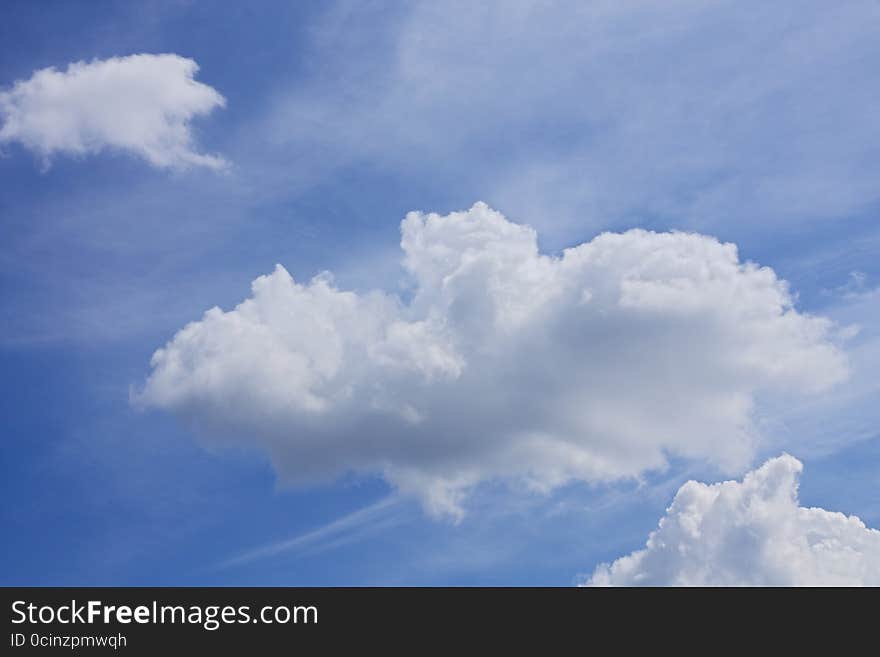 Fluffy white clouds in the blue sky. Fluffy white clouds in the blue sky