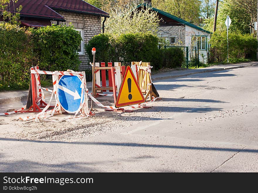 Blue and yellow warning signs on road repairs in the city. Blue and yellow warning signs on road repairs in the city