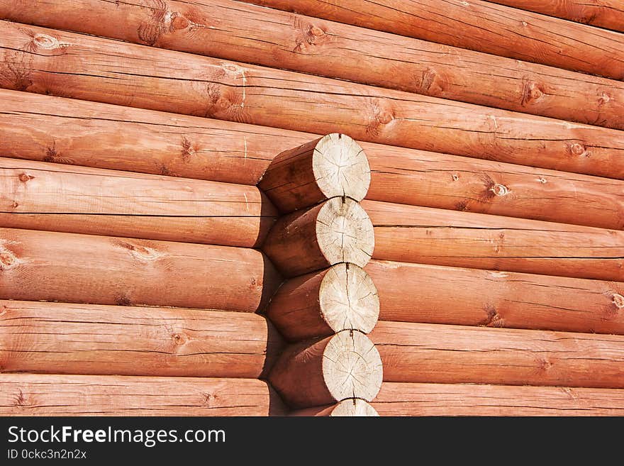 New brown log house wall outside closeup on sunny day