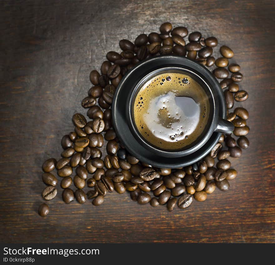 Cup of hot coffee on wooden background