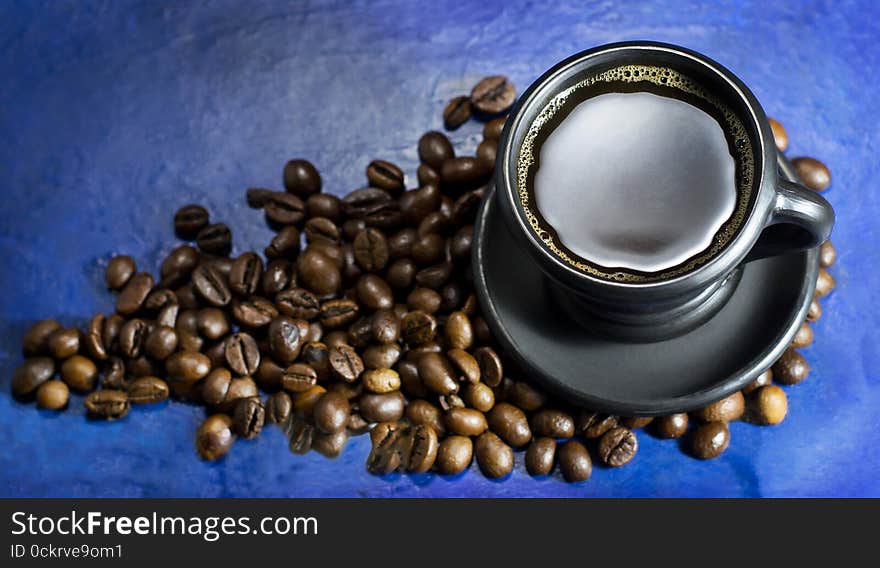 Cup of hot coffee on the old blue background