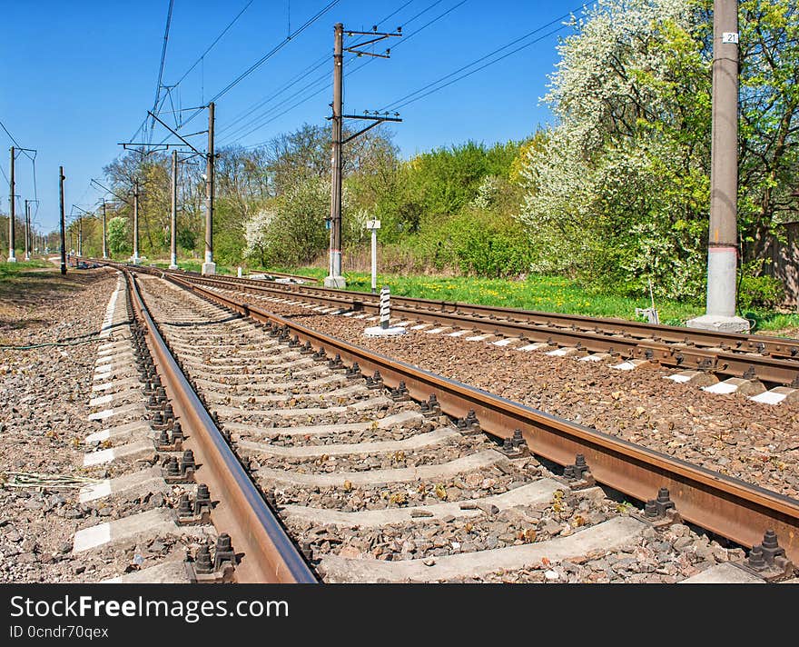 Railway receding into the distance on sunny spring day