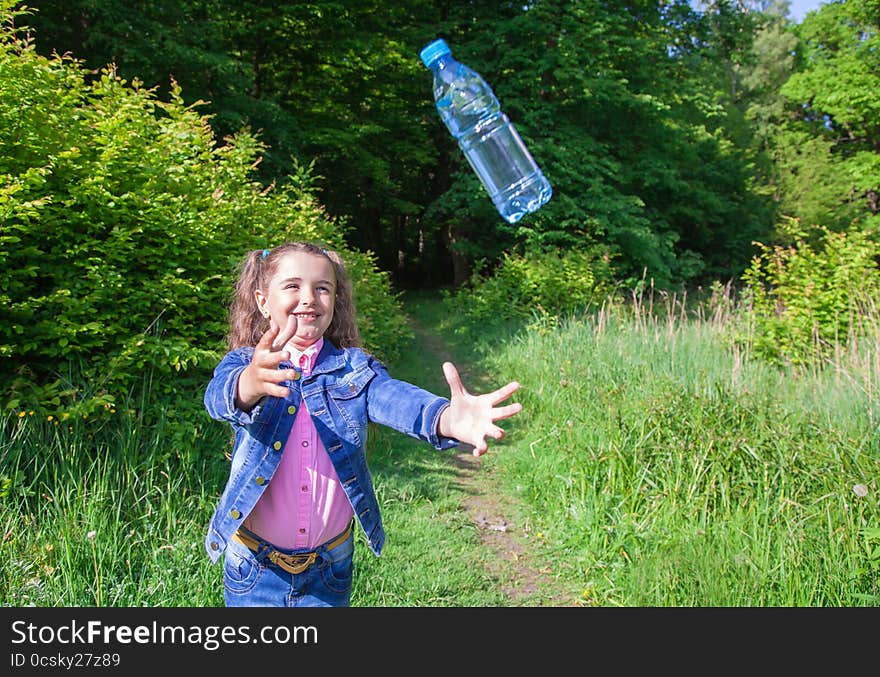 Girl Catching A Plastic Bottle