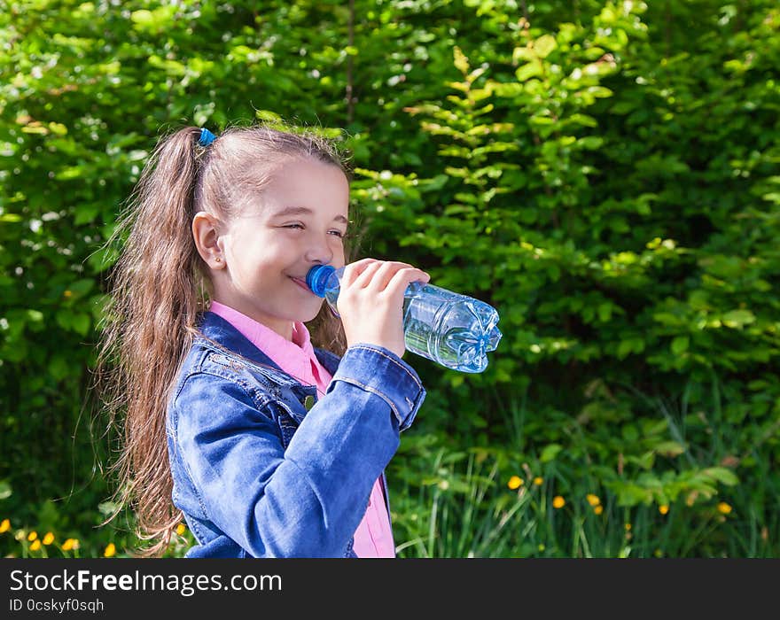 Girl Drinks Water From A Plastic Bottle