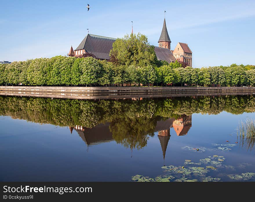 River landscape with cathedral on sunny summer day