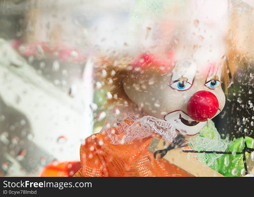 Sad clown toy in the storefront