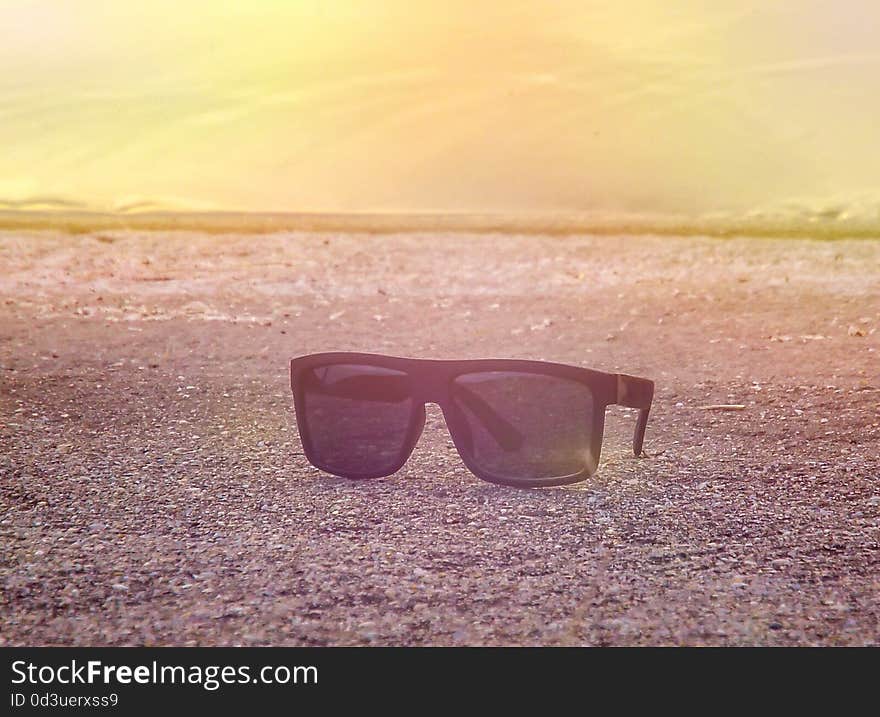 Summer picture with sunglasses on the beach in the sunny morning. Summer picture with sunglasses on the beach in the sunny morning