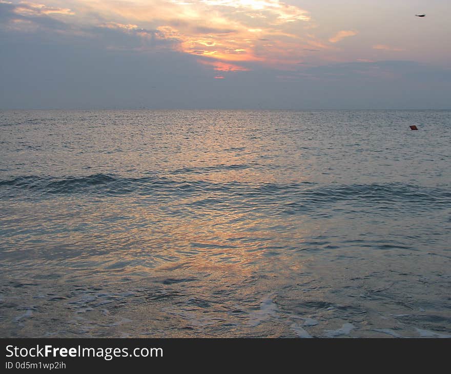 View of the beautiful and calm sea, at sunrise. View of the beautiful and calm sea, at sunrise.