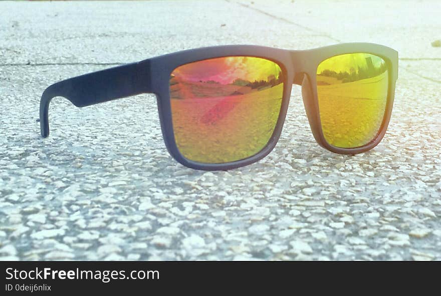 Picture with fashionable colorful sunglases in a sunny day of summer and beautiful landscape on the lake