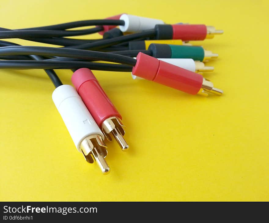 Picture with rca audio video communication cable isolated on a yellow background. Picture with rca audio video communication cable isolated on a yellow background