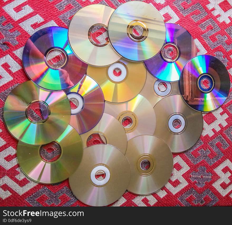 Colorful computer compact disks equipment on the table. Colorful computer compact disks equipment on the table