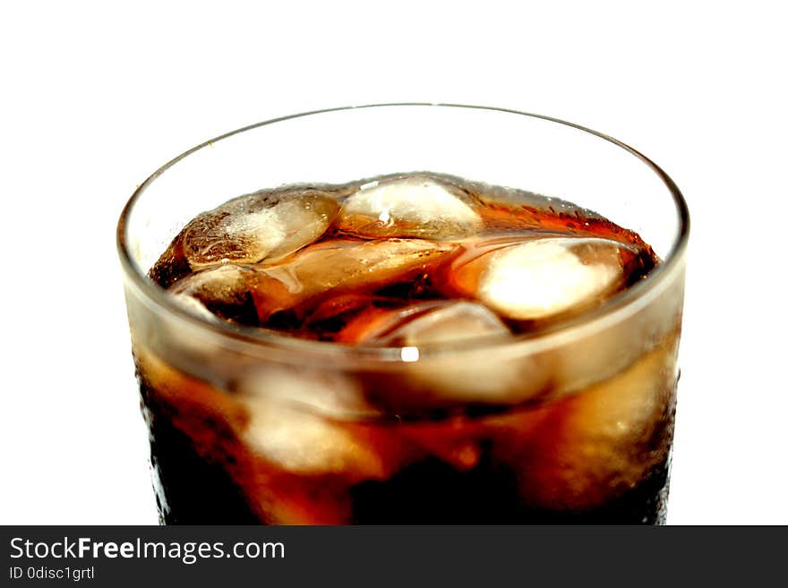 He drink is a brownish-black color, chilled with ice in a glass, in the glass, in glass. He drink is a brownish-black color, chilled with ice in a glass, in the glass, in glass